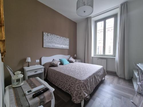 a small bedroom with a bed and a window at Nel cuore del Centro Storico in Turin
