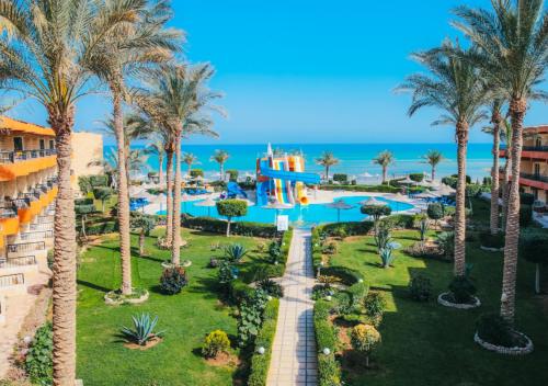 an aerial view of a resort with a pool and palm trees at Retal View Resort El Sokhna Aqua Park in Ain Sokhna