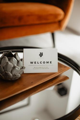 a welcome sign sitting on a table at Joy Aparthotel Keilberg in Klínovec