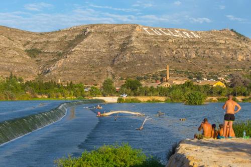 a group of people standing on the edge of a river at Cullera Panoramic Sea Views Apartment in Cullera