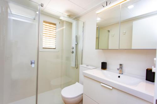 a bathroom with a shower and a toilet and a sink at Cullera Panoramic Sea Views Apartment in Cullera