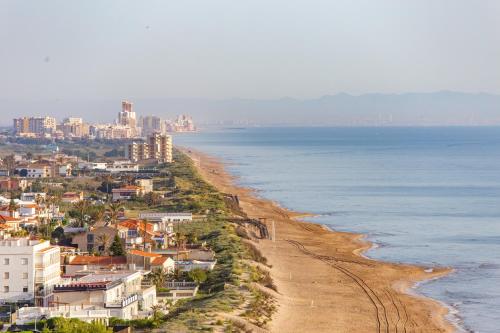 a view of a beach with buildings and the ocean at Cullera Panoramic Sea Views Apartment in Cullera