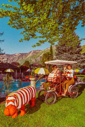 a group of people riding on a train with a pig and aroller at Amadeus Ora & Amore in Caldaro