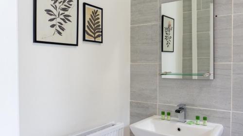 a bathroom with a sink and a mirror at Bevington House - Air Host & Stay - 3 Bedroom Close to City Centre in Liverpool