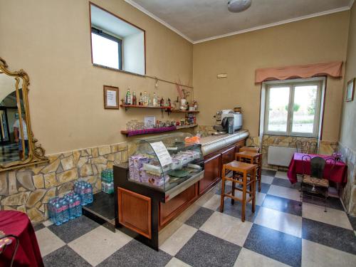 a restaurant with a counter and a mirror in a room at Hotel Silverado in Aversa