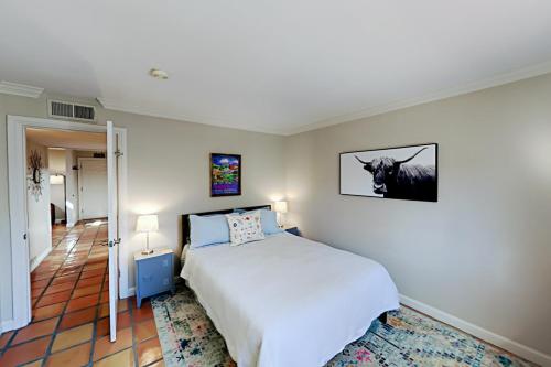 a bedroom with a bed and a picture of a cow on the wall at Plazadise in Santa Fe