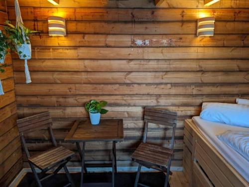 a room with two chairs and a table and a bed at Hausboot mit Hottub in Berlin in Berlin