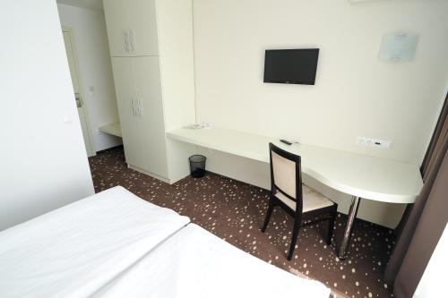 Postel nebo postele na pokoji v ubytování City Hotel Krško