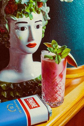 a doll and a drink and a book on a table at Amadeus Ora & Amore in Caldaro