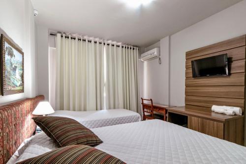 Ένα ή περισσότερα κρεβάτια σε δωμάτιο στο Hotel San Rafael