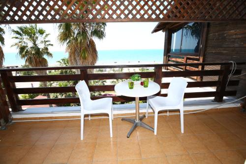 a table and chairs on a balcony with the beach at Hotel Venezia in Golem