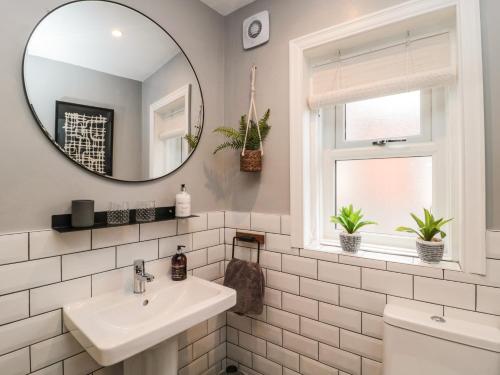 a bathroom with a sink and a mirror at Marden Mews in Whitley Bay