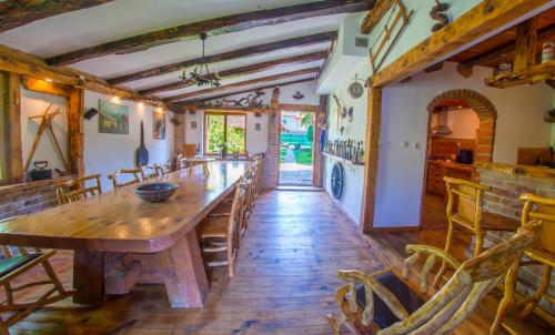 a large dining room with a wooden table and chairs at Ranc Vitina in Ljubuški