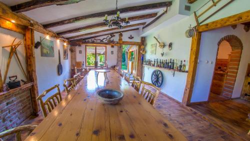 a dining room with a wooden table and chairs at Ranc Vitina in Ljubuški