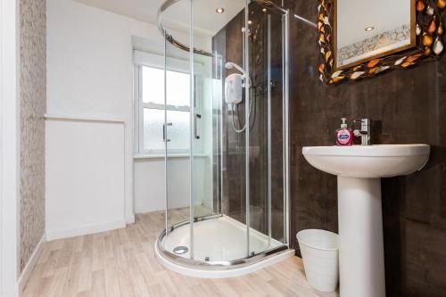 a bathroom with a shower and a sink at The Auld Sweetie Shop in Perth