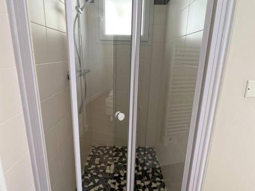 a shower with a glass door in a bathroom at Appartement Cambo-les-Bains, 2 pièces, 2 personnes - FR-1-495-12 in Cambo-les-Bains