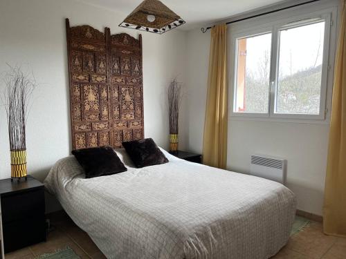 a bedroom with a large bed and a window at Appartement Cambo-les-Bains, 2 pièces, 2 personnes - FR-1-495-59 in Cambo-les-Bains