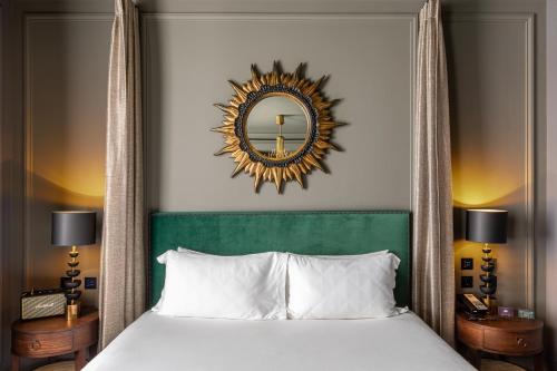 a bedroom with a bed with a mirror above it at The Mandrake in London