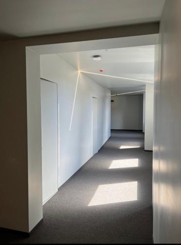 an empty hallway with white walls and a ceiling at SAVOIE Apartments Bukovel in Bukovel