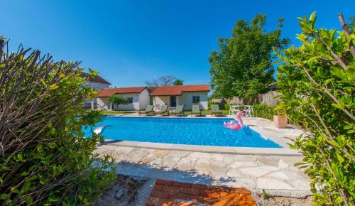 a swimming pool in the backyard of a house at Ranc Vitina in Ljubuški