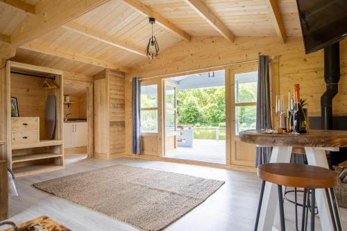 a kitchen with wooden walls and a large window at Nestledstays- Primrose in Arundel