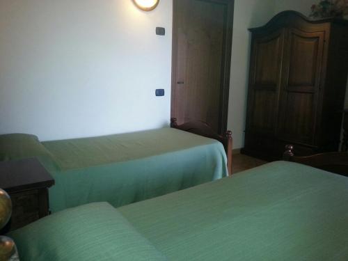 a hotel room with two beds and a door at Agriturismo Cascina del Peso in Leinì