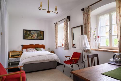 a bedroom with a bed and a table and chairs at House 1797 - Charm of Slovenian Vintage in Dob