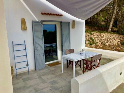 a table and chairs on the patio of a house at Dimora delle Tonnare in Favignana