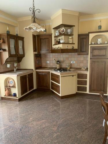 a large kitchen with wooden cabinets and a stove at Casa Giò in Ariano Irpino