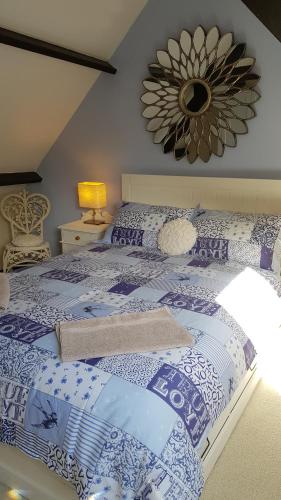 a blue and white bed in a room at Maroux Vian Country Cottage in Callac