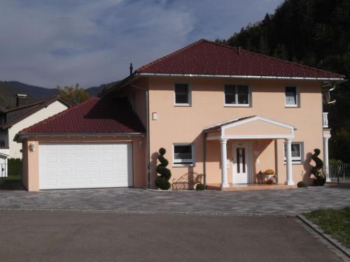 a large house with a white garage at Toscana-Residenz im Schwarzwald in Utzenfeld