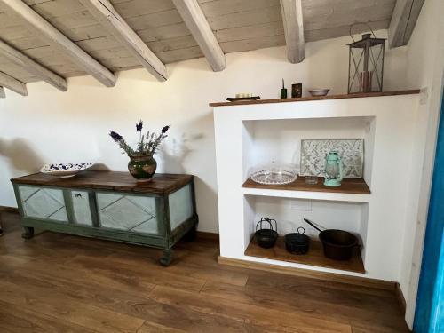 a room with a table and a shelf at donna serena Aci Castello in Aci Castello
