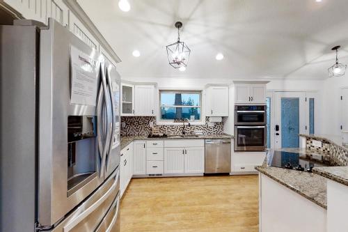 a kitchen with white cabinets and stainless steel appliances at Panoramic View in Maynardville