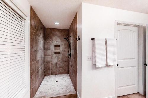 a bathroom with a walk in shower next to a white door at Panoramic View in Maynardville