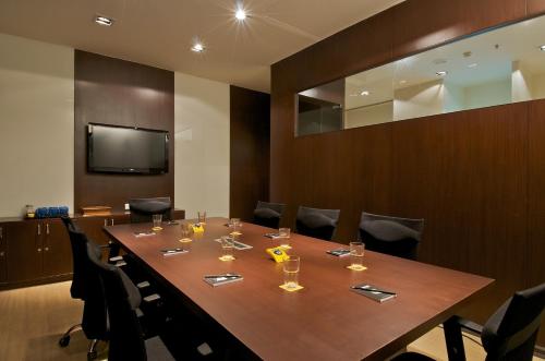 a conference room with a long wooden table and chairs at Keys Select by Lemon Tree Hotels, Thiruvananthapuram in Trivandrum