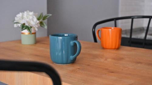 two cups sitting on top of a wooden table at Likya 202 in Demre