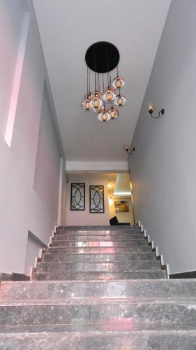 a staircase in a building with a chandelier at Likya 202 in Demre