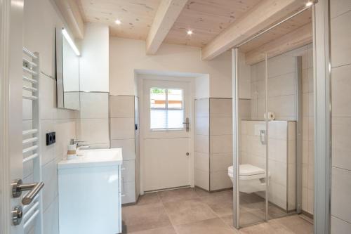 a bathroom with a toilet and a sink at Dünenkate Dünenkate in Sankt Peter-Ording