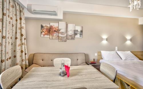 a room with a dining table and a bed at 3SSS Bouquet Studios in Marmarion