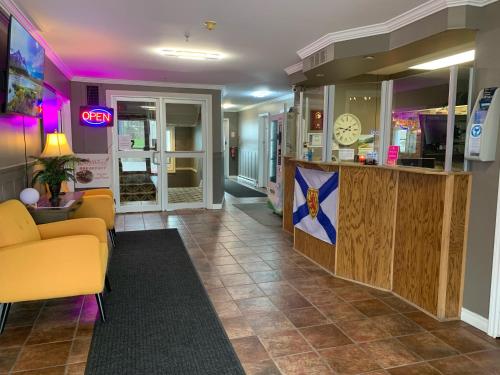 a lobby with a yellow couch and a counter at Harbourview Inn and Suites in Sydney