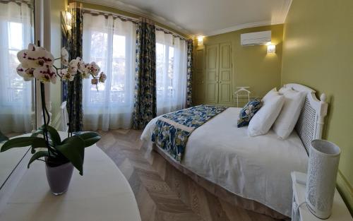 En eller flere senge i et værelse på La Maison V.H., Appartements d'Hôtes