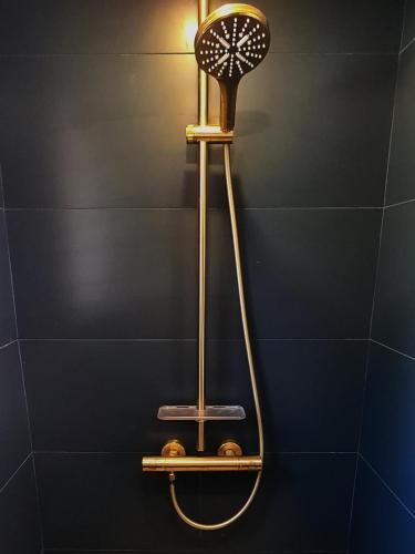 a bathroom with a shower with a fan on the wall at Villa Martinus in Saint-Paul-de-Vence