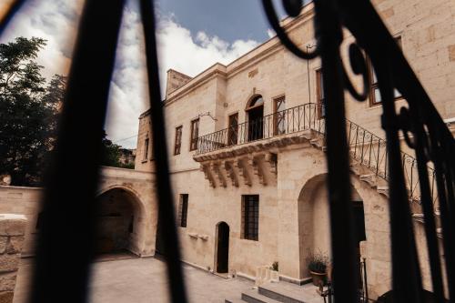 an old building with a balcony and stairs at House 1938 Special Cave Hotel in Ortahisar