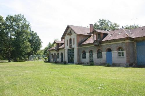 a large house with a grass field in front of it at B&B Le Logis de Bois Renard in Saint Laurent Nouan