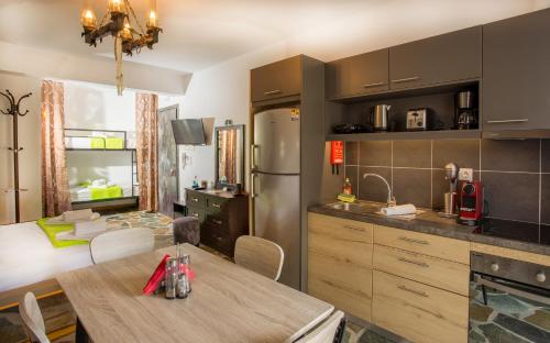 a kitchen with a table and a dining room at 3SSS Bouquet Studios in Marmarion