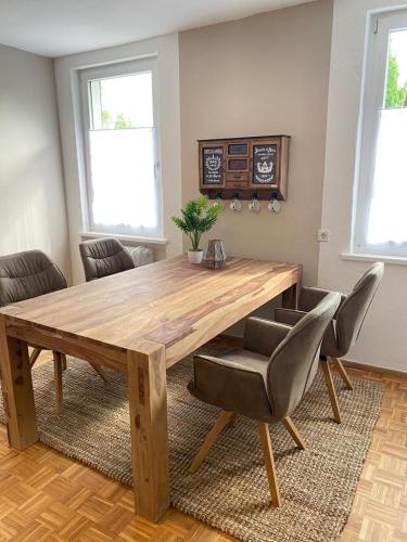 a wooden table and chairs in a living room at Gasthof - Auszeit im Bad Diezlings - Adults only in Hörbranz