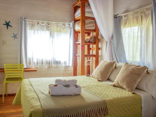 a bedroom with a bed and a bunk bed at Bon Amour Punta del Diablo in Punta Del Diablo