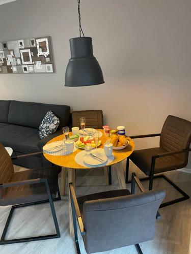 a dining room with a table with food on it at Ankertau in Norden