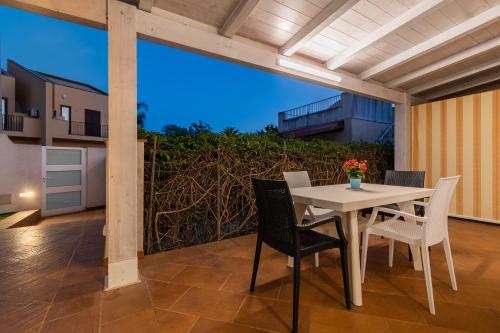 a table and chairs on a patio with a view at Casammare in Marina di Modica