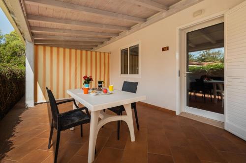 a white table and chairs on a patio at Casammare in Marina di Modica